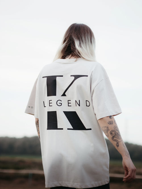 Beige K-Legend Collection Essential T-shirt displayed on a hanger with a simple, minimalist background.